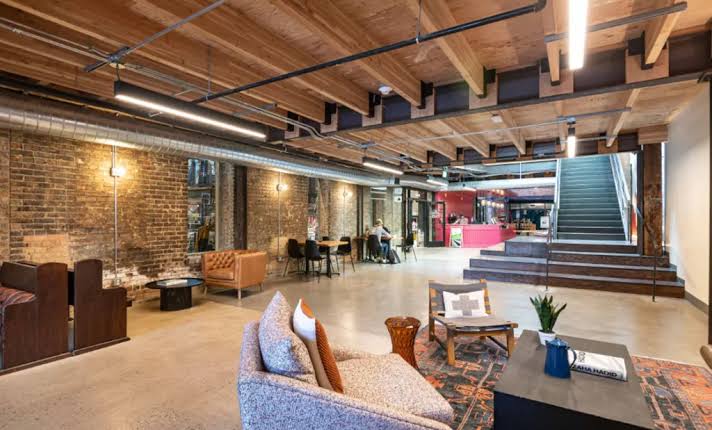 Brick-walled lounge with linear pendant lighting
